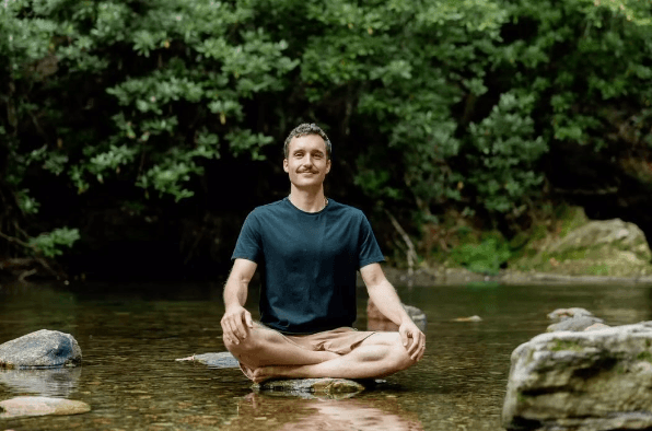 Dr. Cameron meditating by the river